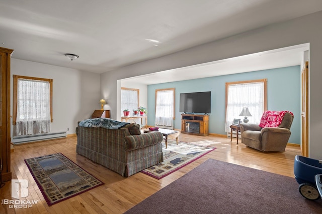 living room with a baseboard radiator and light wood-type flooring