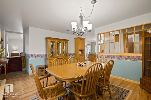 dining room featuring light hardwood / wood-style floors and a chandelier