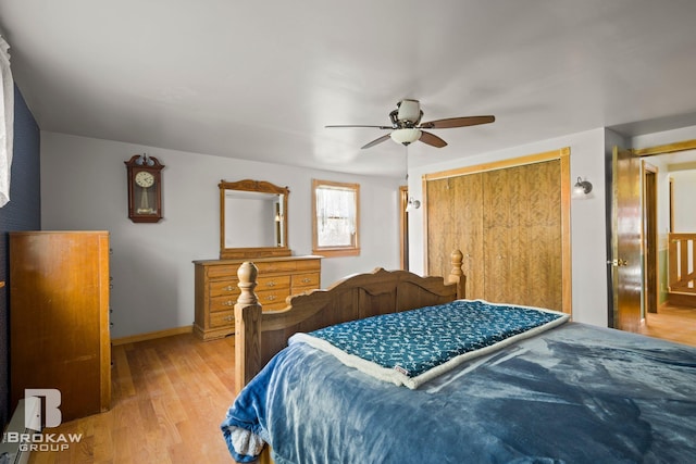 bedroom with a closet, light wood-type flooring, and ceiling fan