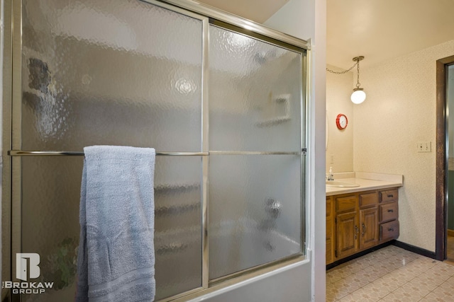 bathroom with vanity, enclosed tub / shower combo, and tile patterned floors