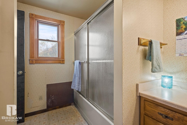 bathroom featuring vanity and bath / shower combo with glass door