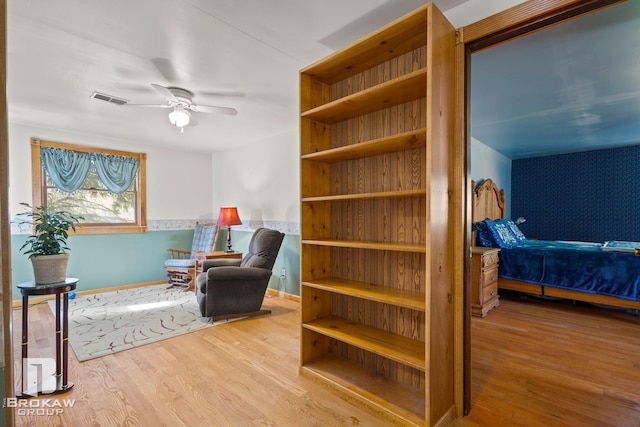 living area featuring ceiling fan and wood-type flooring