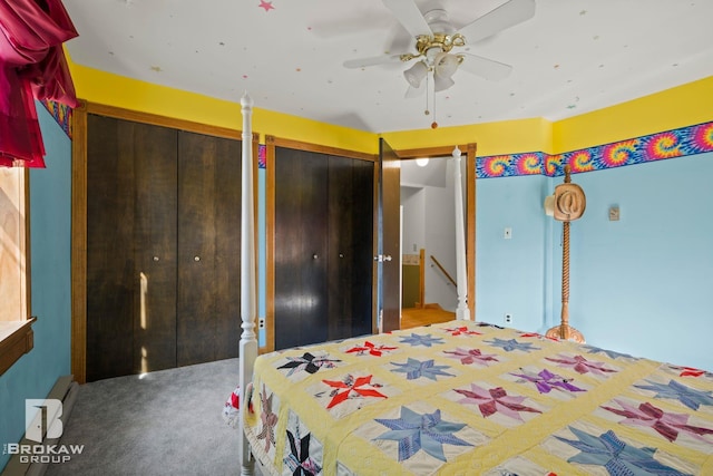 carpeted bedroom with multiple closets and ceiling fan