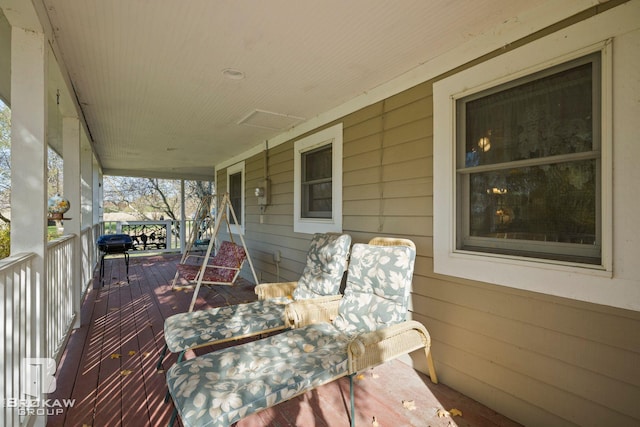 wooden terrace with a porch