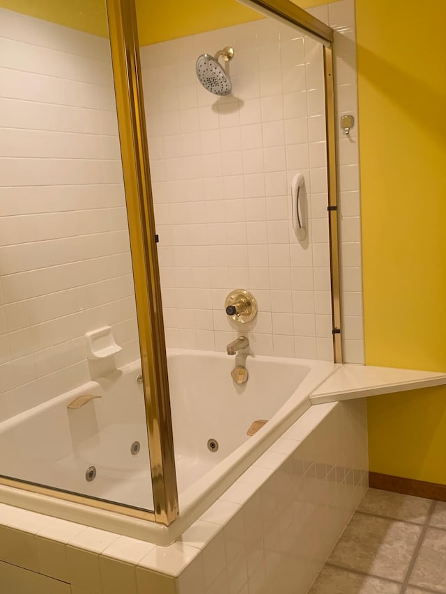 bathroom with tiled shower / bath and tile patterned floors