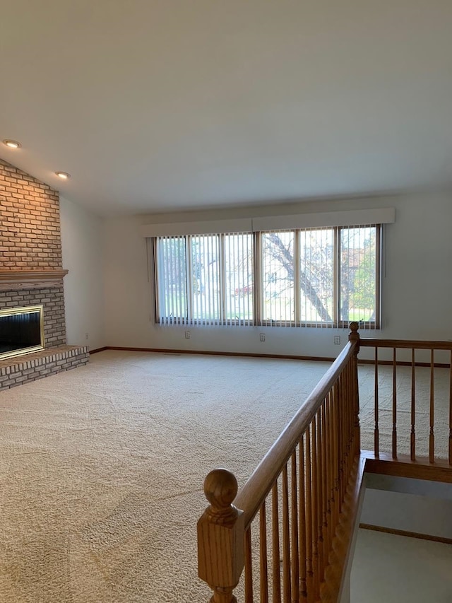 interior space featuring lofted ceiling and carpet