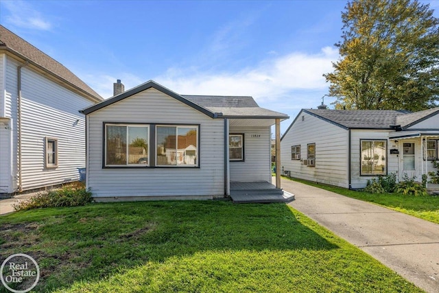 bungalow featuring a front yard and cooling unit