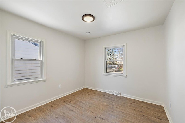 empty room with hardwood / wood-style flooring