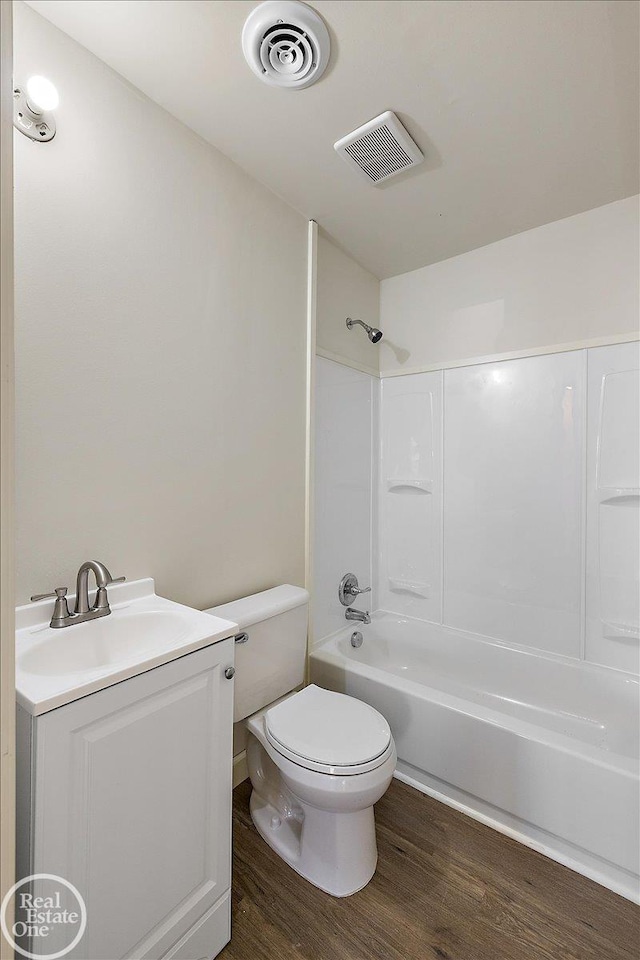 full bathroom with vanity, shower / tub combination, hardwood / wood-style flooring, and toilet