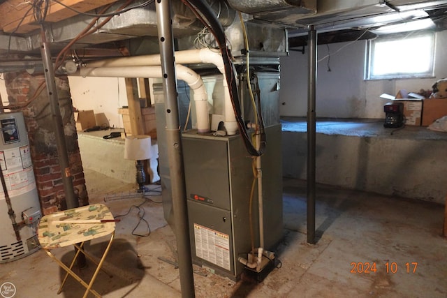 utility room with gas water heater and heating unit