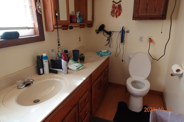 bathroom featuring vanity, toilet, and hardwood / wood-style flooring