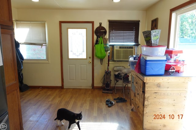 foyer entrance with cooling unit and hardwood / wood-style flooring