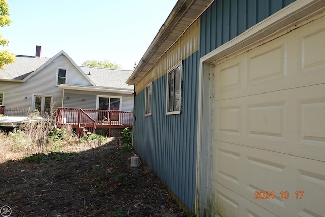 view of side of property with a wooden deck