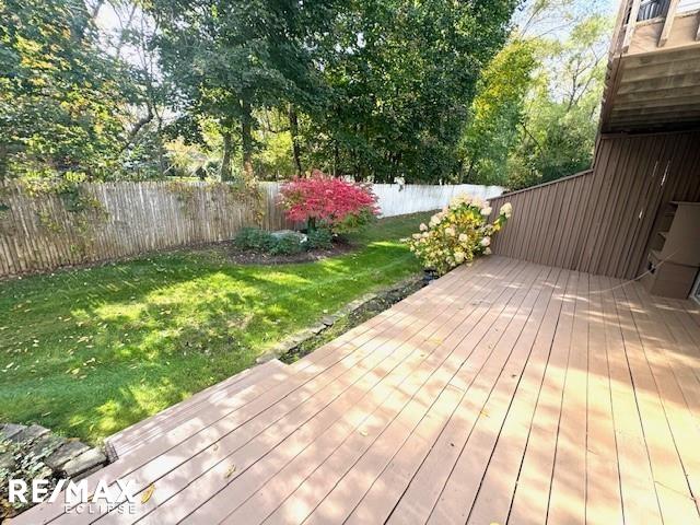 wooden deck featuring a yard