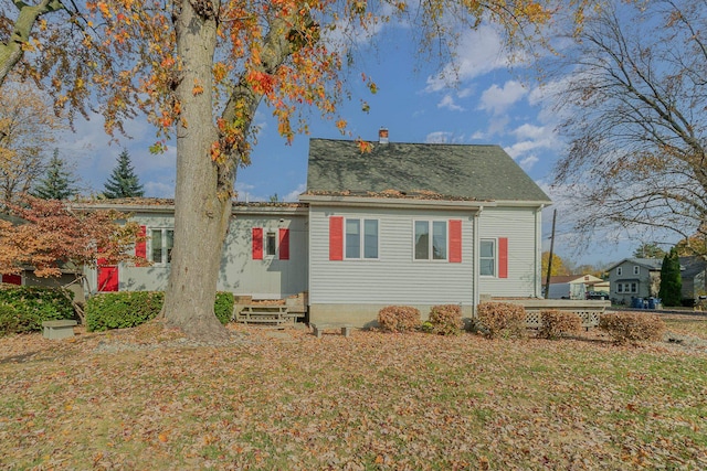 back of property featuring a lawn