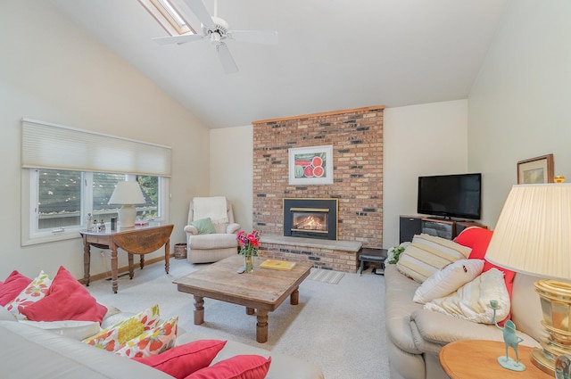 living room featuring light carpet, a fireplace, ceiling fan, and high vaulted ceiling