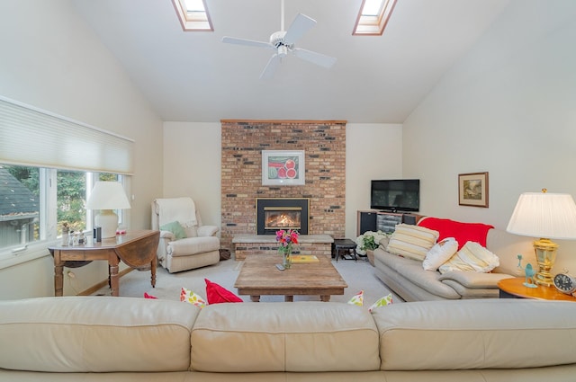 living room with ceiling fan, light colored carpet, high vaulted ceiling, and a brick fireplace