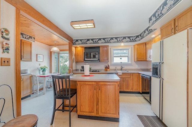 kitchen featuring stainless steel microwave, a wealth of natural light, white fridge with ice dispenser, and black dishwasher