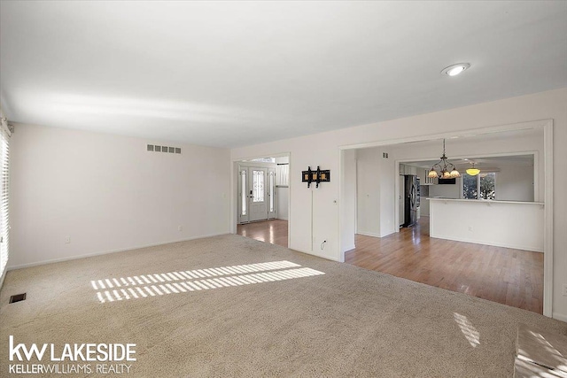 unfurnished living room with hardwood / wood-style floors and plenty of natural light