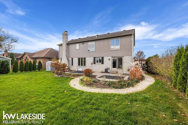 back of house featuring a patio and a yard