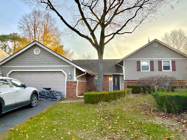 view of front of house with a yard and a garage