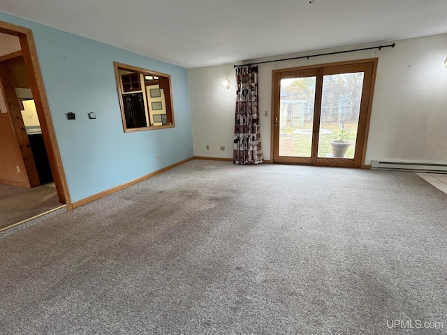 carpeted spare room featuring baseboard heating