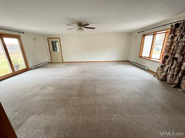 carpeted empty room featuring baseboard heating and ceiling fan