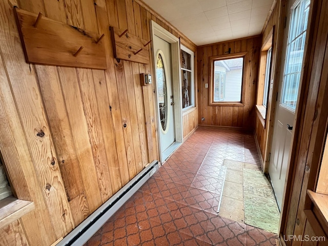 entryway featuring wooden walls and a baseboard radiator