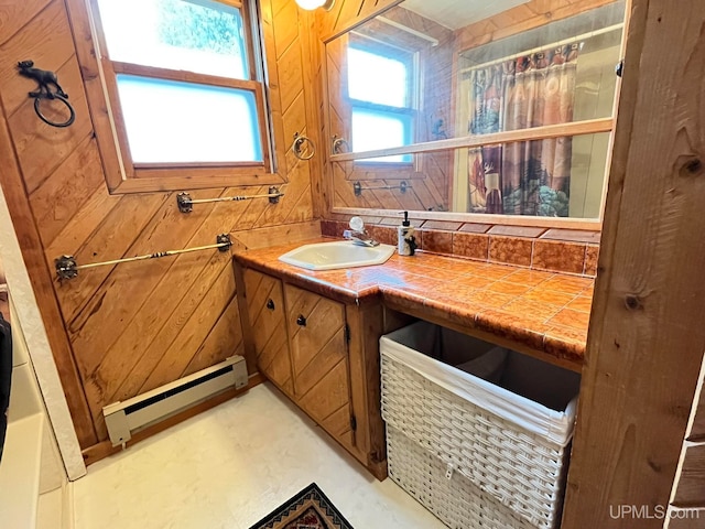 bathroom with vanity, baseboard heating, and wooden walls