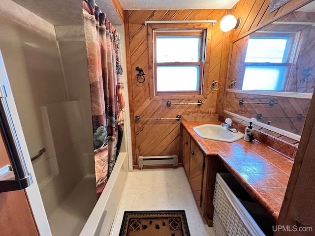 bathroom featuring baseboard heating, vanity, wooden walls, and shower / bath combo with shower curtain