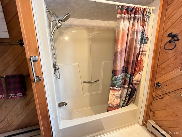 bathroom with wooden walls, a baseboard radiator, and shower / tub combo