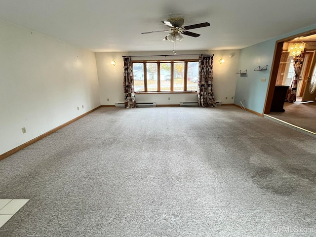 carpeted spare room with ceiling fan and a baseboard heating unit