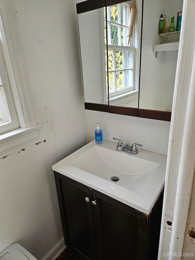 bathroom featuring vanity and toilet