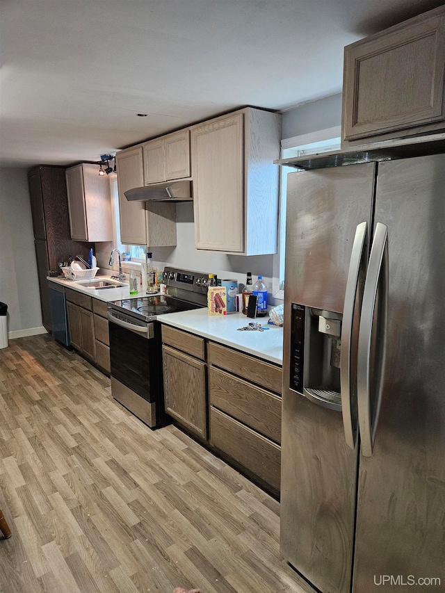 kitchen featuring sink, light hardwood / wood-style flooring, and stainless steel appliances