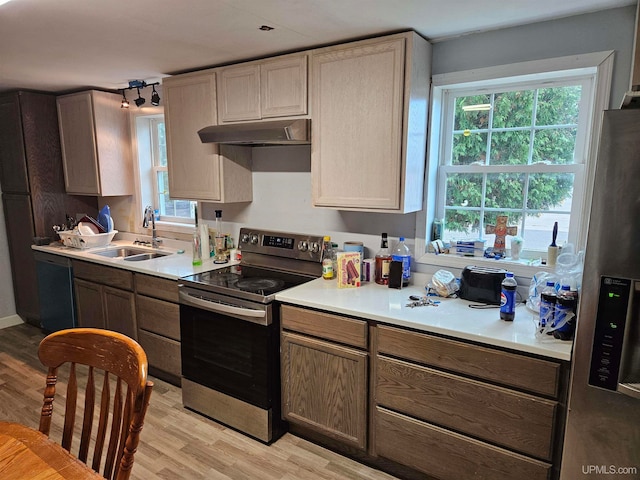 kitchen featuring appliances with stainless steel finishes, light hardwood / wood-style flooring, sink, and light brown cabinets