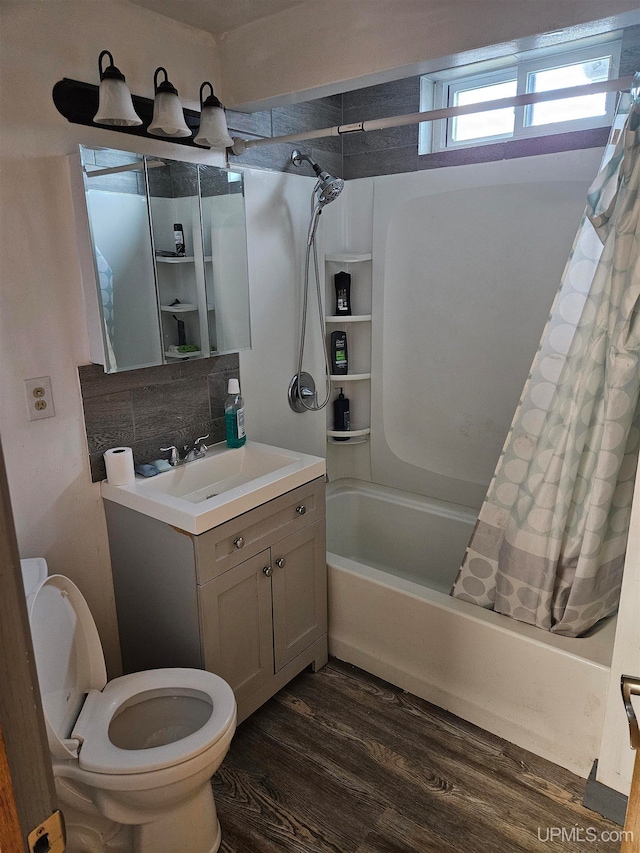 full bathroom with decorative backsplash, hardwood / wood-style floors, shower / bathtub combination with curtain, toilet, and vanity