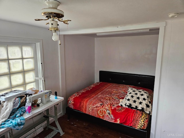 bedroom with dark wood-type flooring and ceiling fan