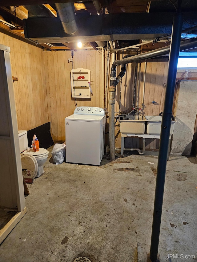 basement with washer / dryer and wooden walls