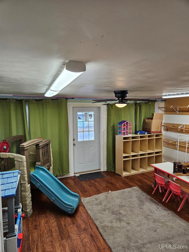 interior space featuring a textured ceiling and dark hardwood / wood-style flooring