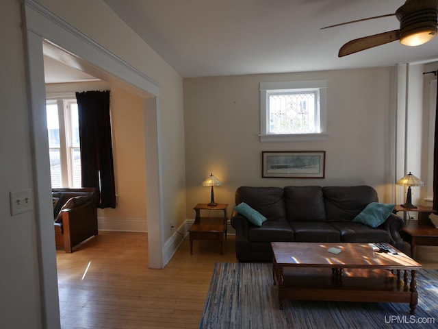 living room featuring wood-type flooring and ceiling fan