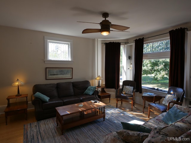 living room with a wealth of natural light, wood-type flooring, and ceiling fan