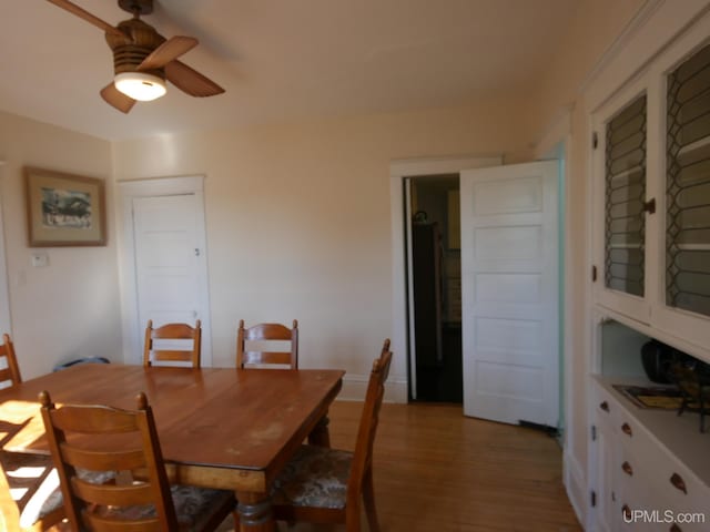 dining space featuring light hardwood / wood-style flooring and ceiling fan