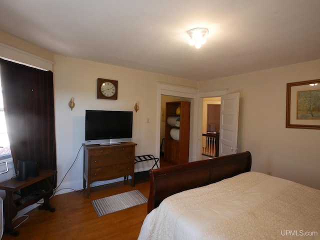 bedroom with hardwood / wood-style flooring