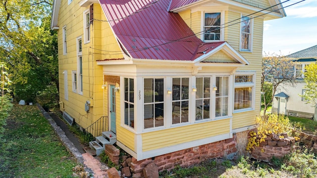 view of side of home with a sunroom