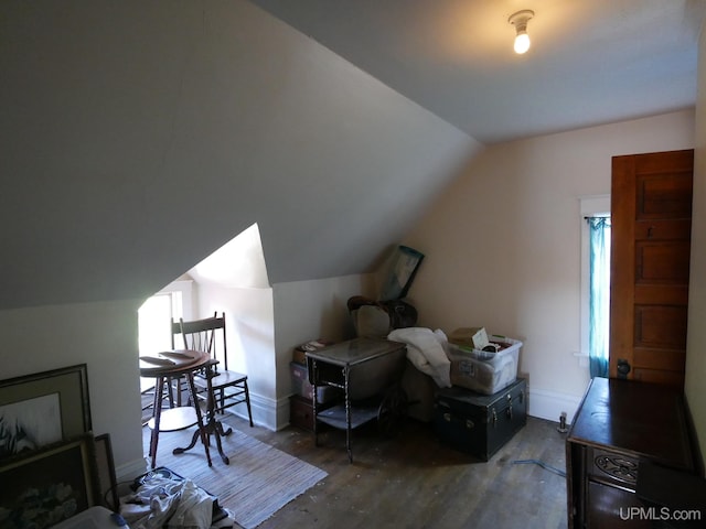 bonus room featuring dark hardwood / wood-style flooring, lofted ceiling, and a wealth of natural light