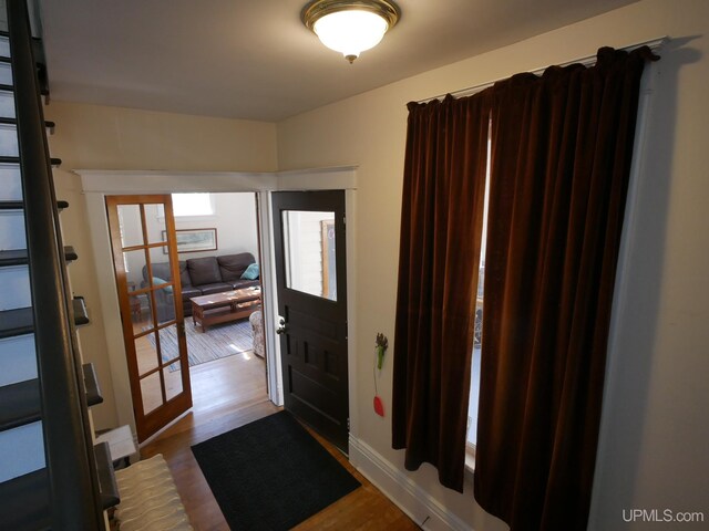 foyer featuring french doors and wood-type flooring