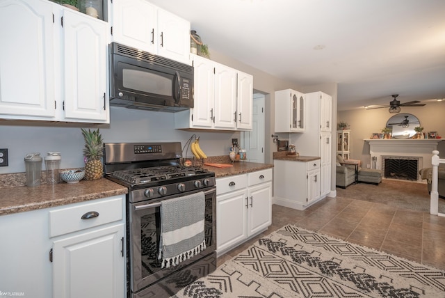 kitchen featuring white cabinetry and stainless steel gas range oven