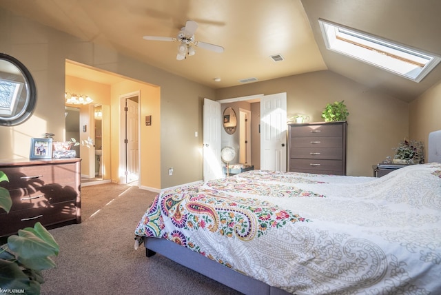 carpeted bedroom with vaulted ceiling with skylight and ceiling fan