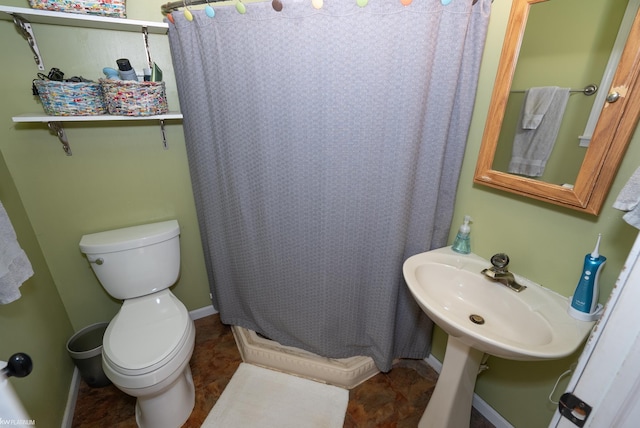 bathroom with toilet, tile patterned flooring, and curtained shower