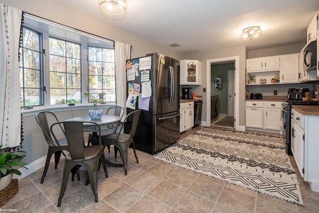 kitchen with black appliances and white cabinets